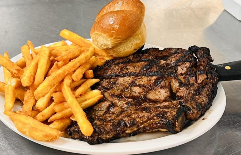 Grilled steak served with fries and a roll at Rockin H